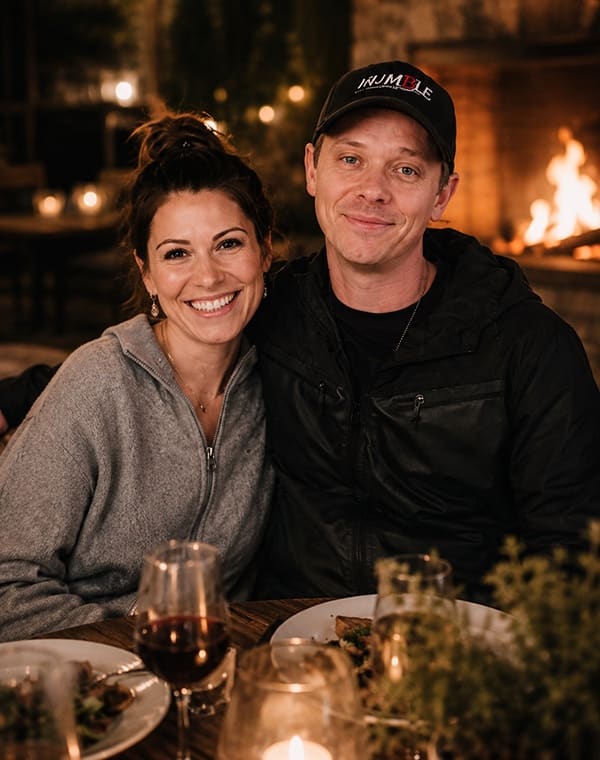 A couple together by the fire on an evening out.